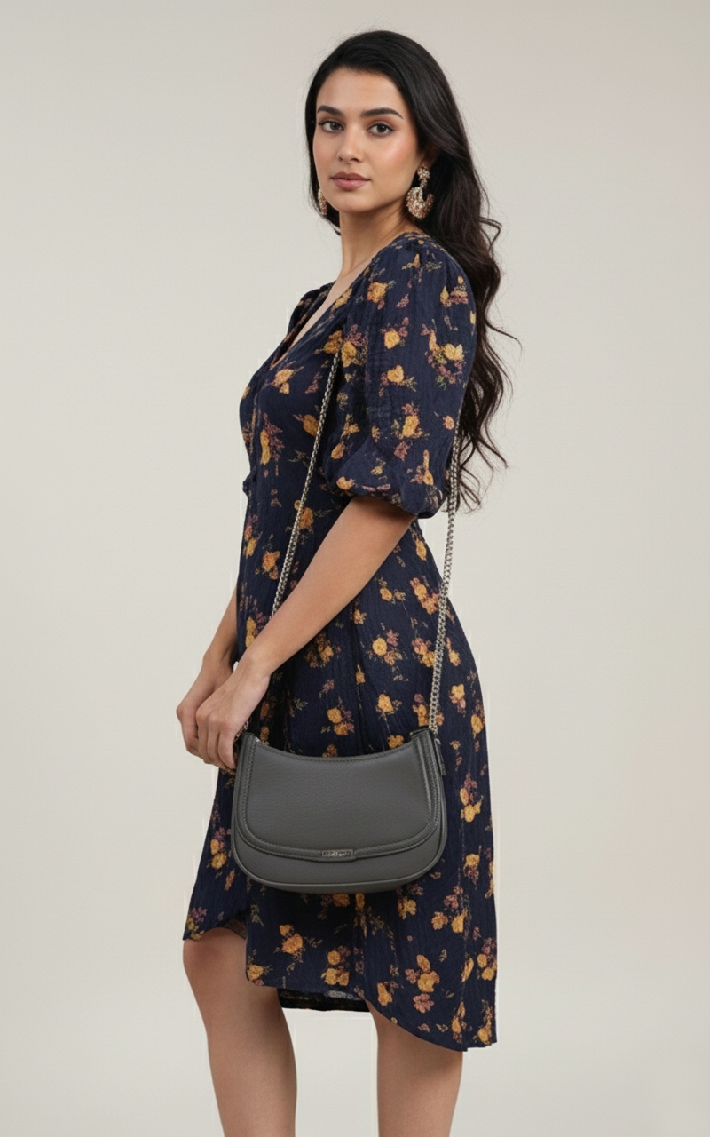 Model wearing the Midnight Bloom navy floral dress with puff sleeves